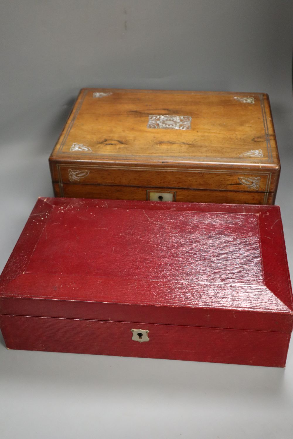A Victorian ivory inlaid rosewood sewing box, width 30cm depth 22cm height 13cm, and a late Victorian red leather cased travelling toil